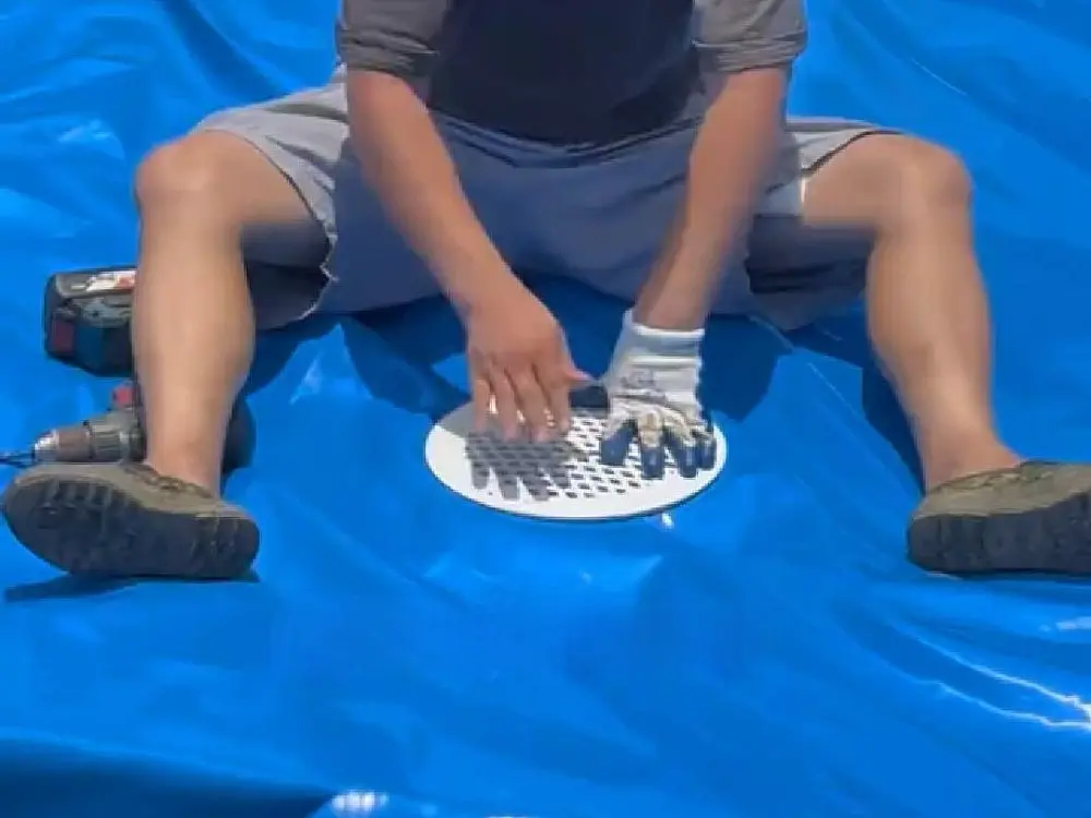 Install bottom central drain for galvanized stock tank pond